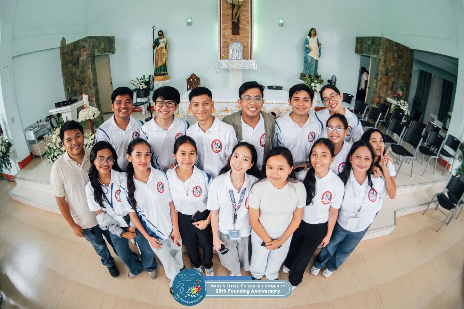 Young members of the Community in white shirts, smiling together in a chapel